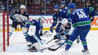 Vancouver Canucks goalie Thatcher Demko stops Winnipeg Jets' Cole Perfetti