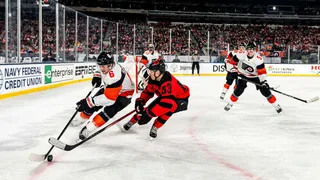 Philadelphia Flyers defenseman Travis Sanheim and New Jersey Devils left wing Jesper Bratt vie for the puck
